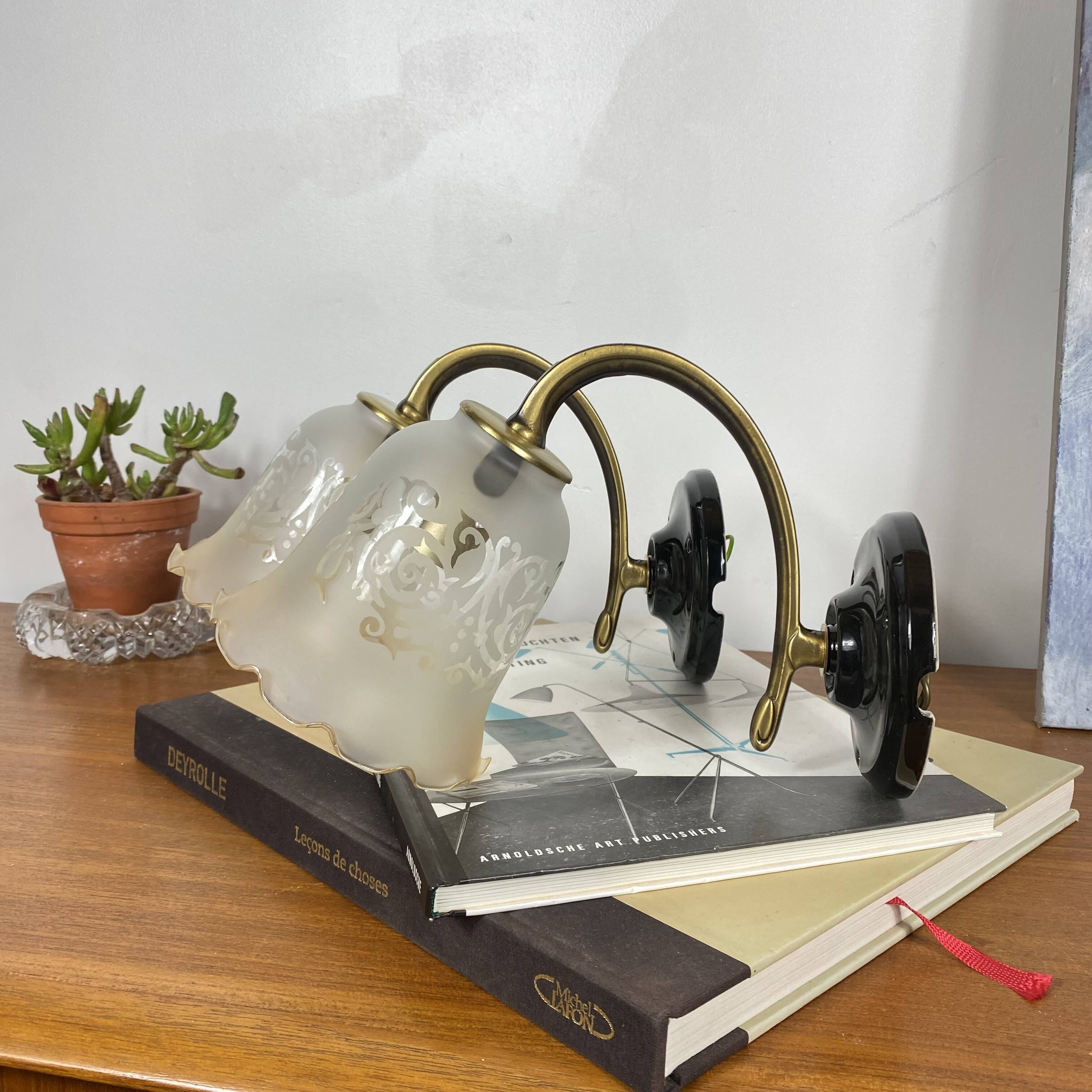 Pair of brass swan neck wall sconces, glass tulips with screen printing.