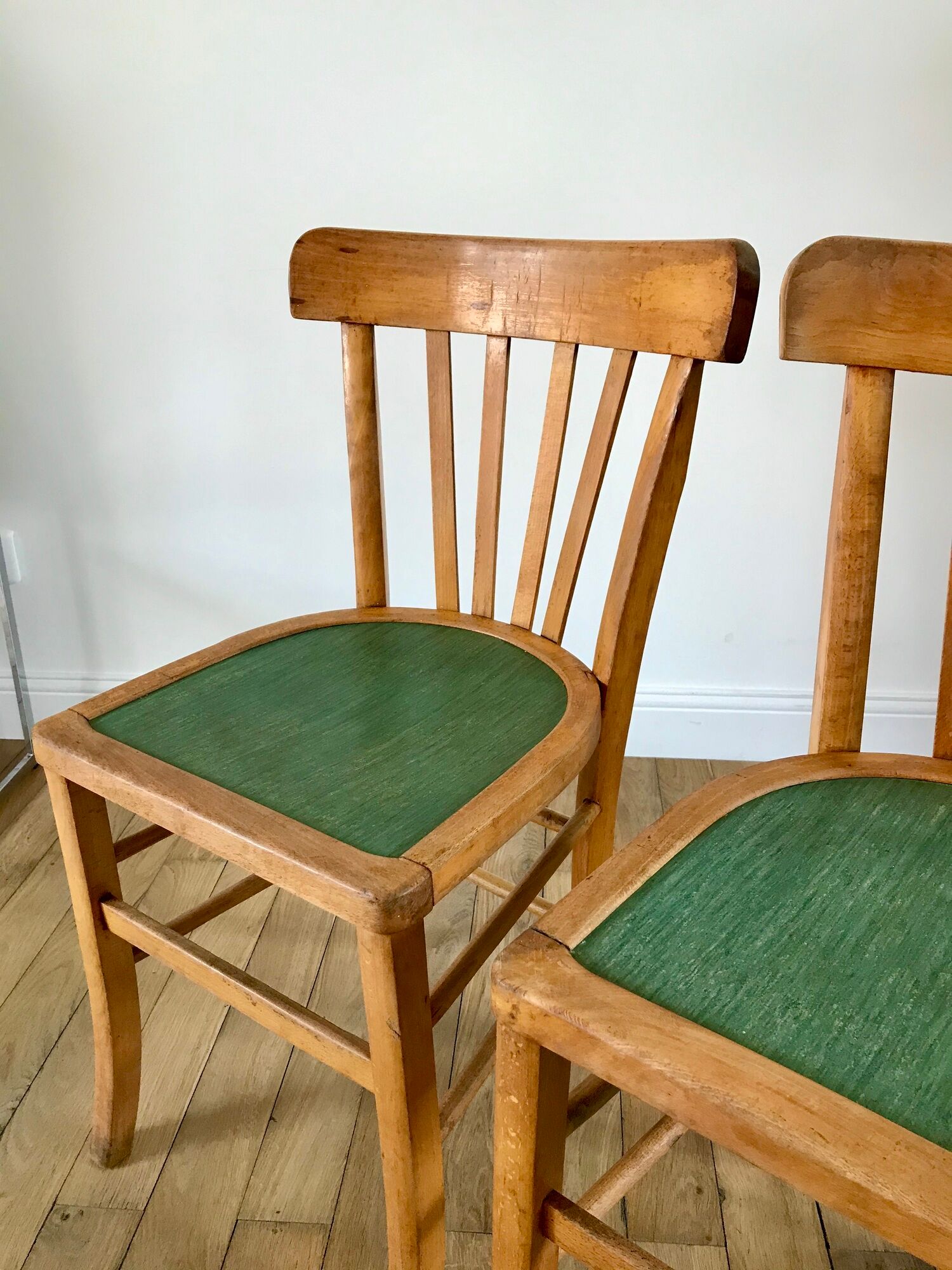 Pair of bistro chairs in light curved wood and green seat 1950s