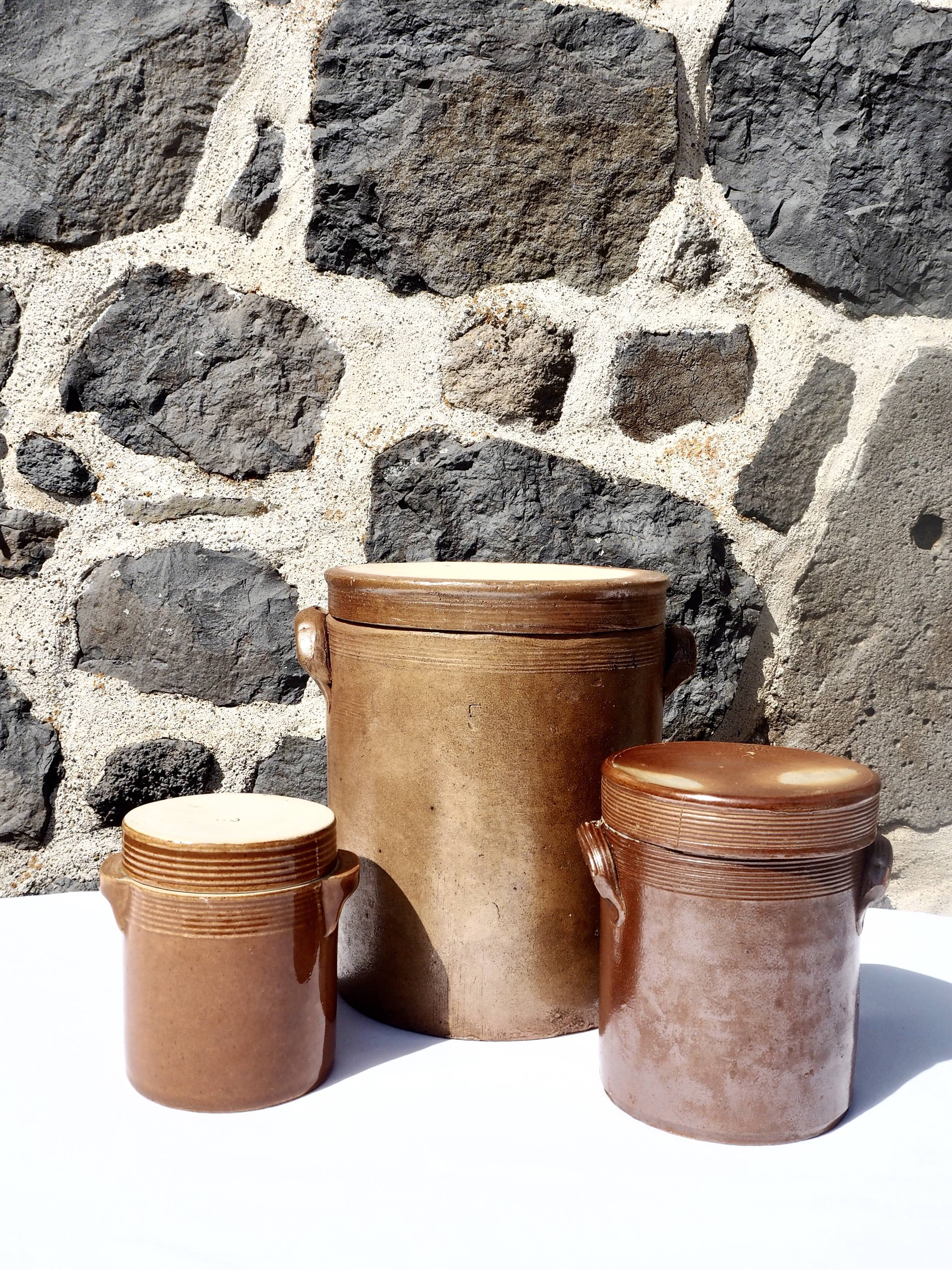 Trio of stoneware pots with lids