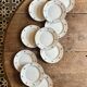 Set of 10 vintage white and gold dessert plates.
