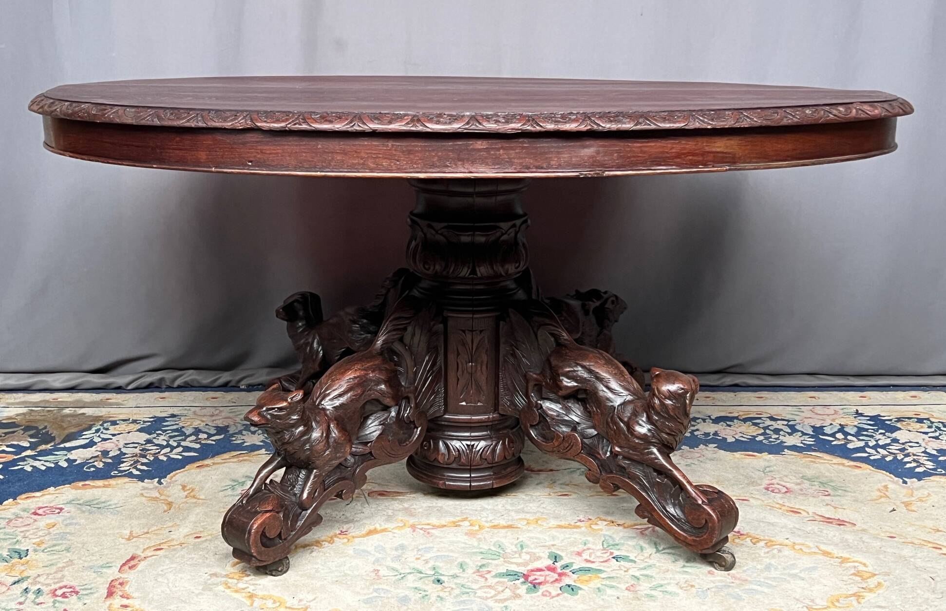 Hunting style dining table with figures of four different animals.