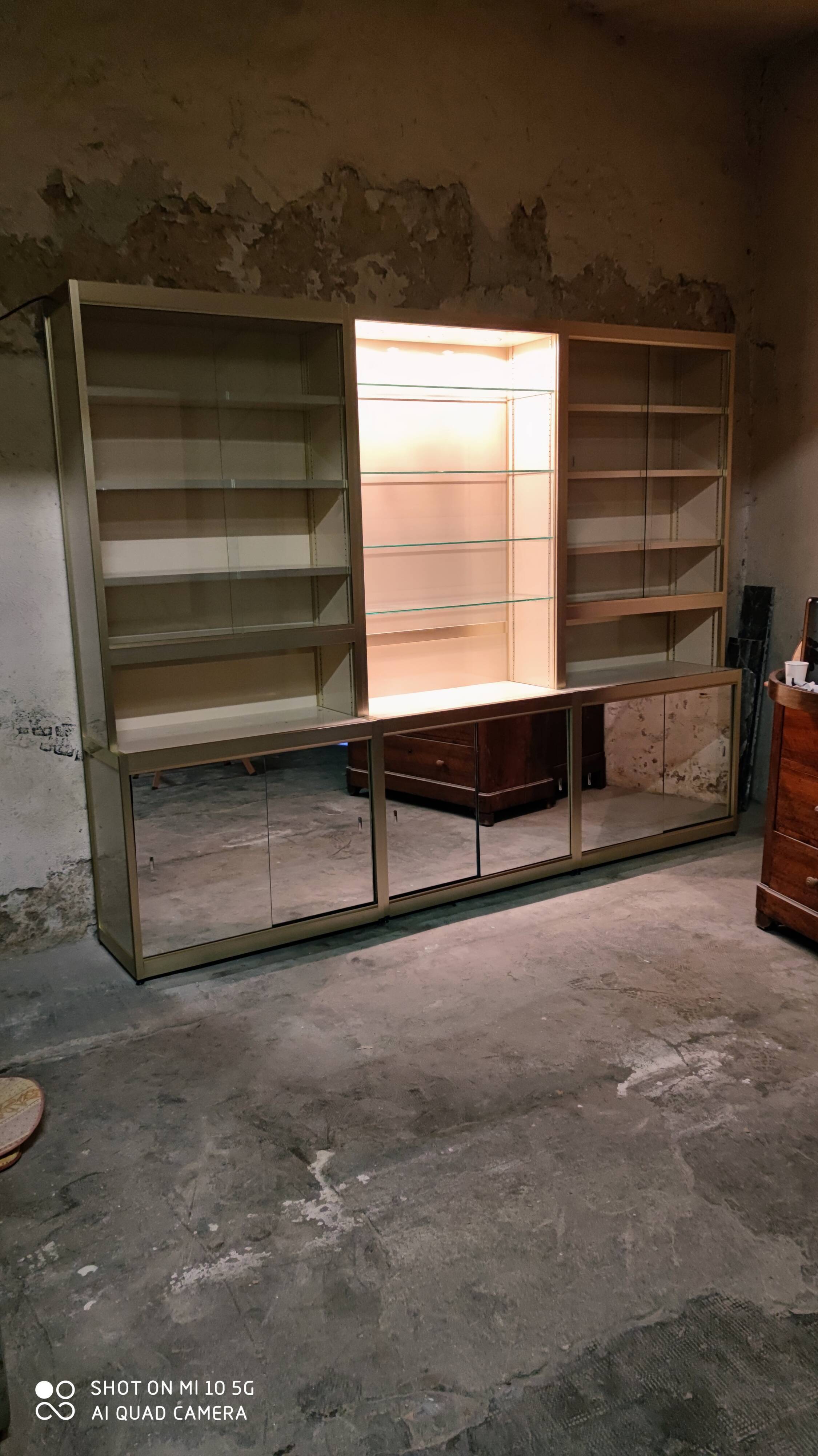 Ivory-colored and matte gold anodized aluminum display bookcase