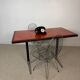 Vintage bistro table with orange-red ceramic.