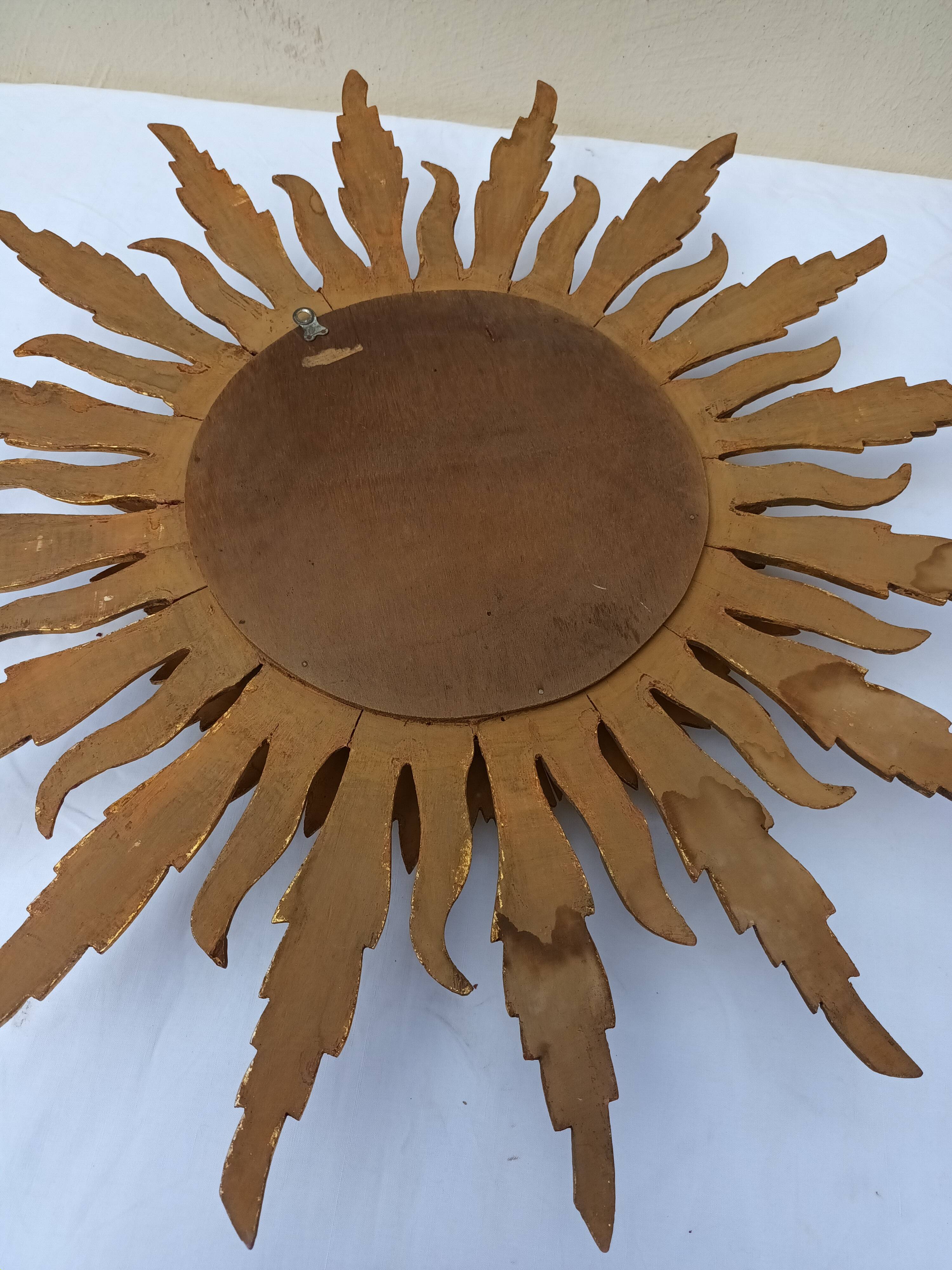 Sun mirror in carved gilded wood from the 1950s