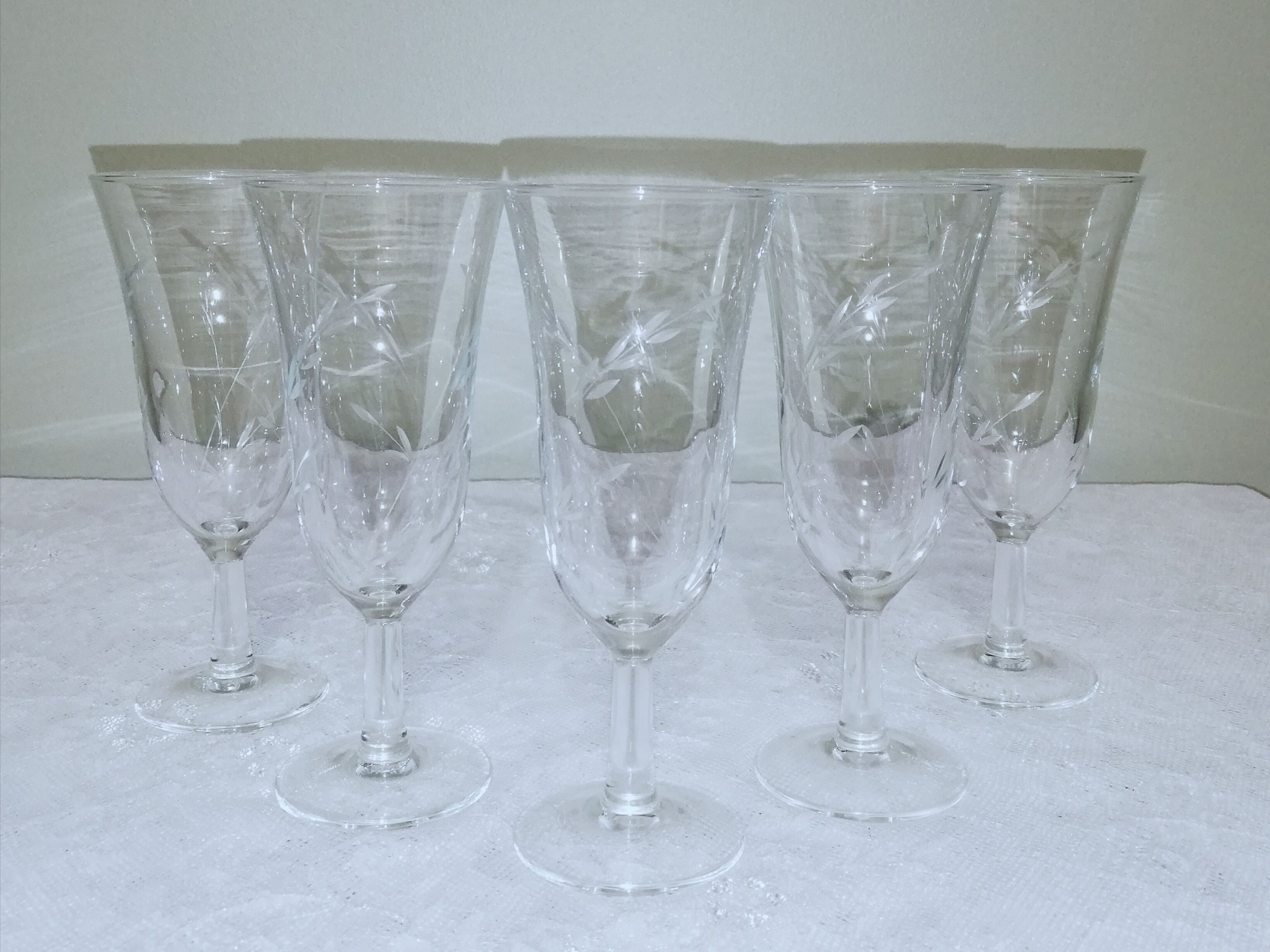 5 champagne flutes decorated with engraved ears