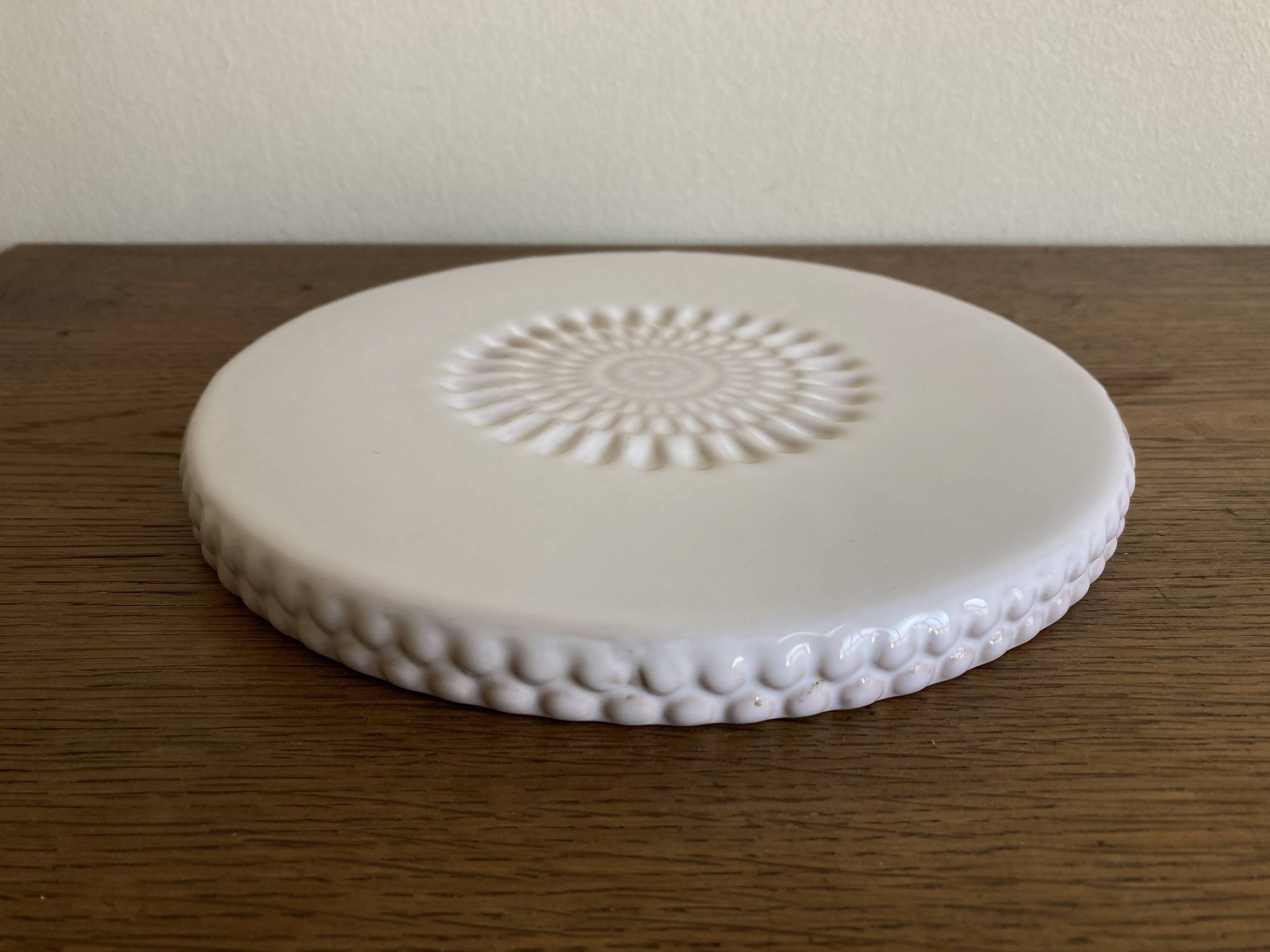 Pierre Motton glazed earthenware scalloped trivet for Gien