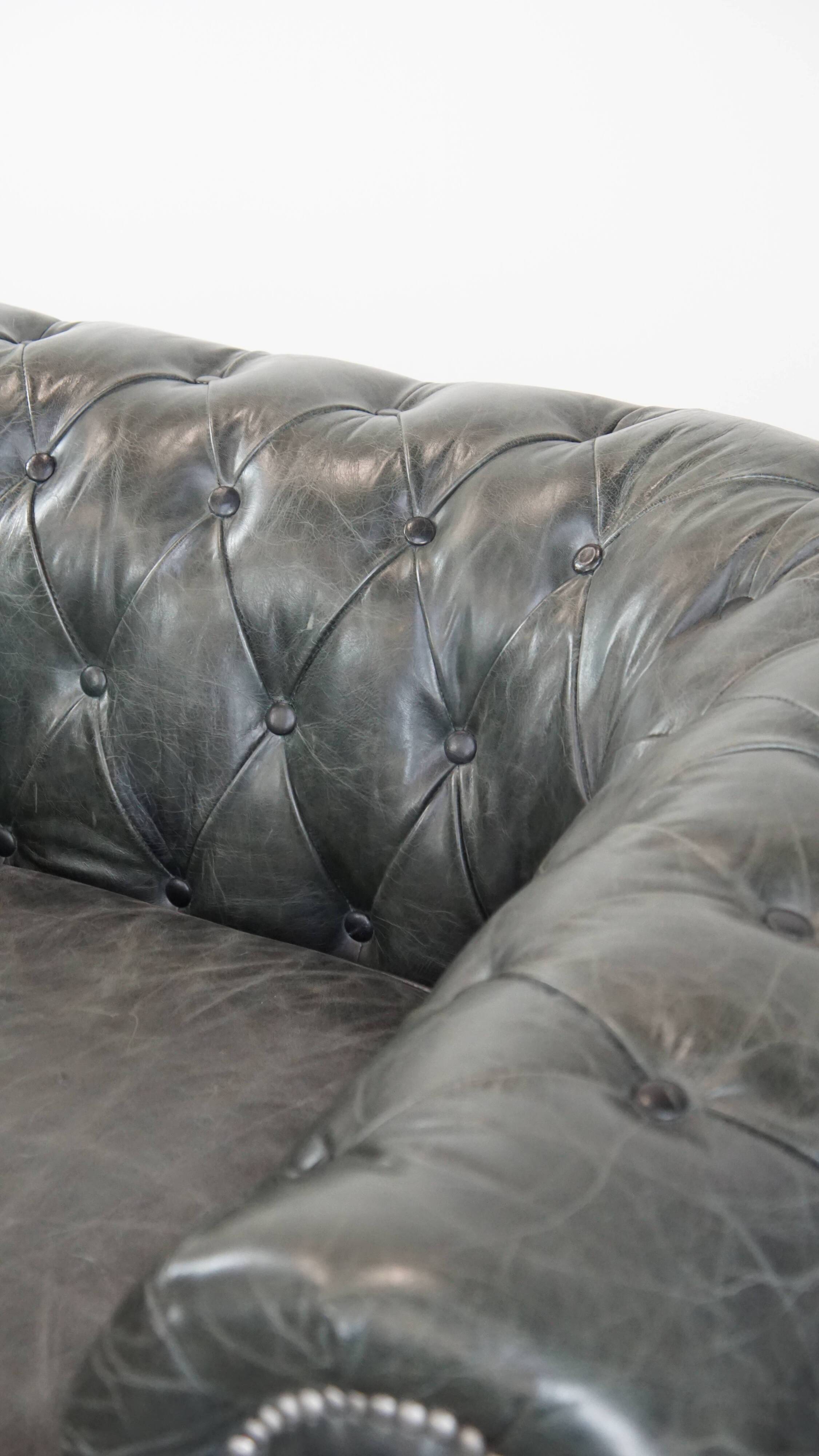 Black Chesterfield armchair made of grained cowhide leather