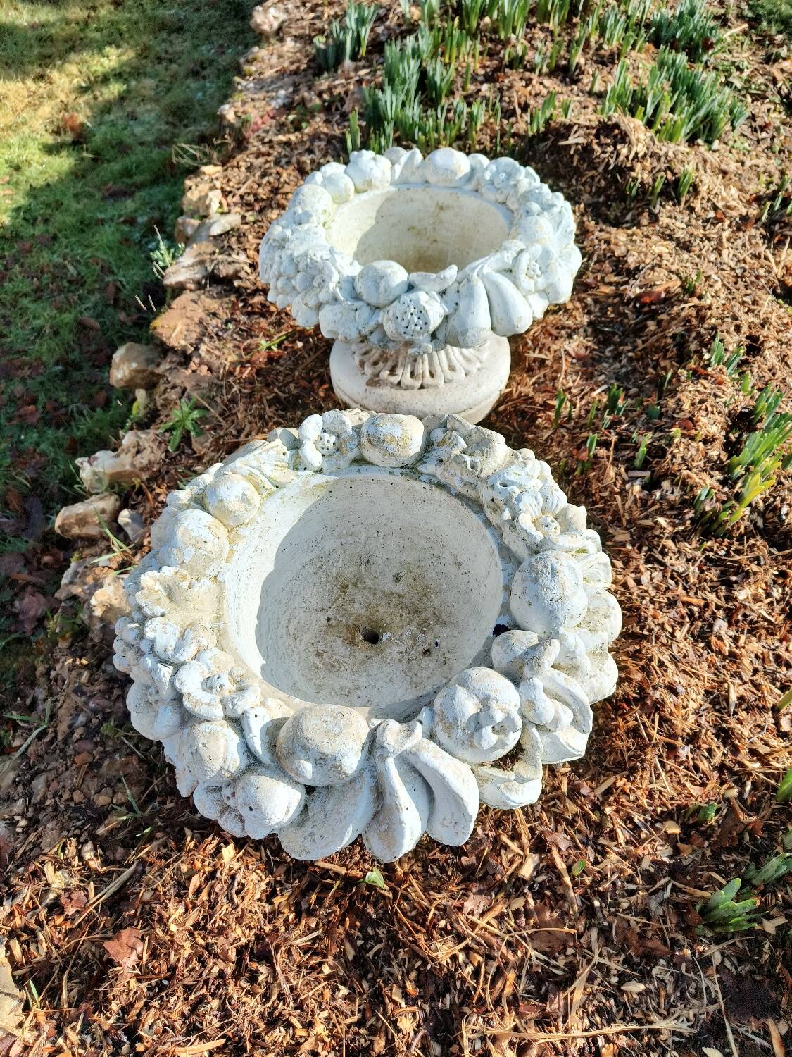 Pair of round stone fruit bowls on foot