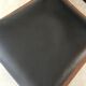 Teak armchair and black leather
