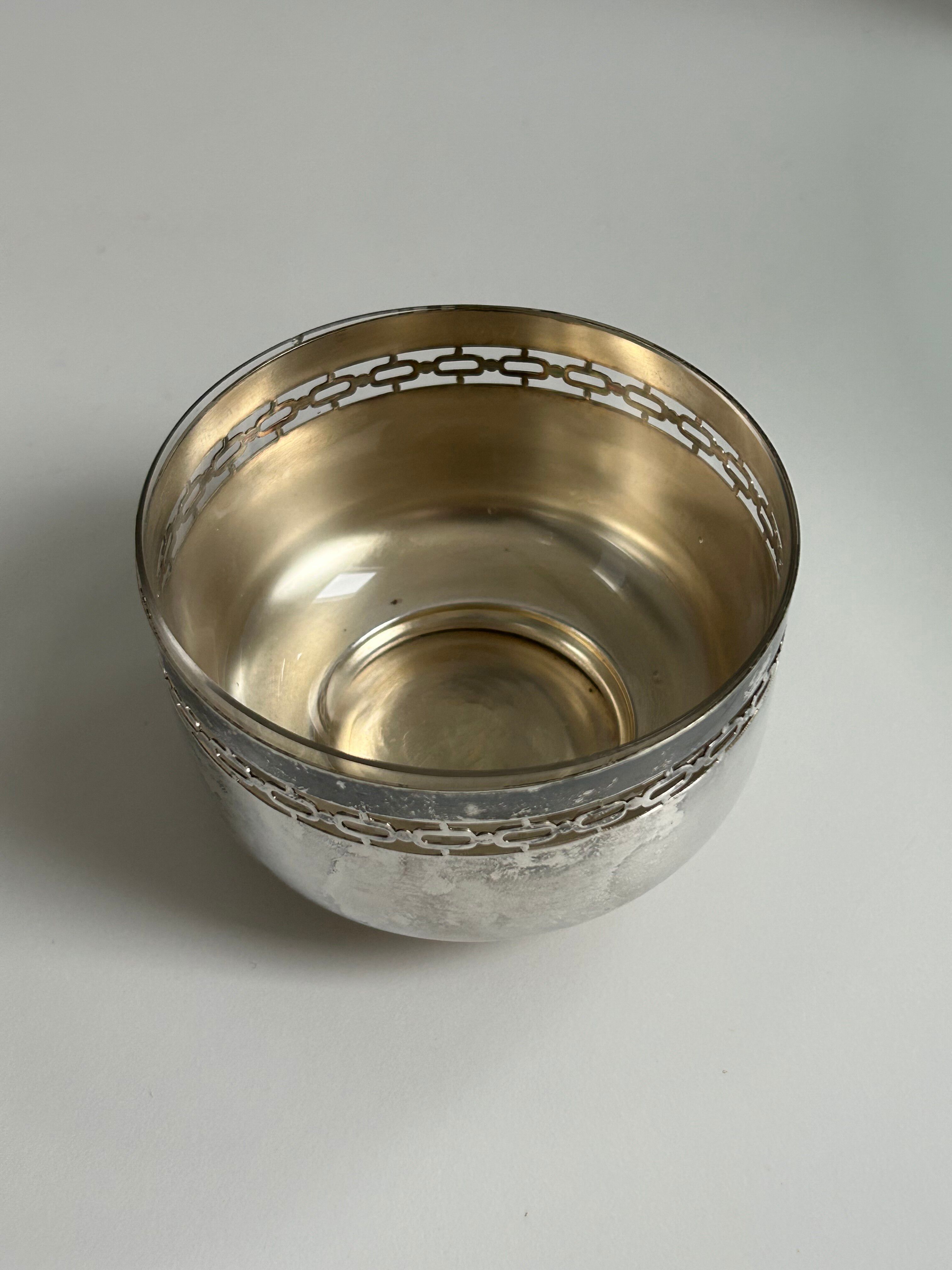 Vintage silver cup with a glass interior.