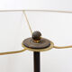 Tripod floor lamp in wrought iron and brass with bamboo-style base.