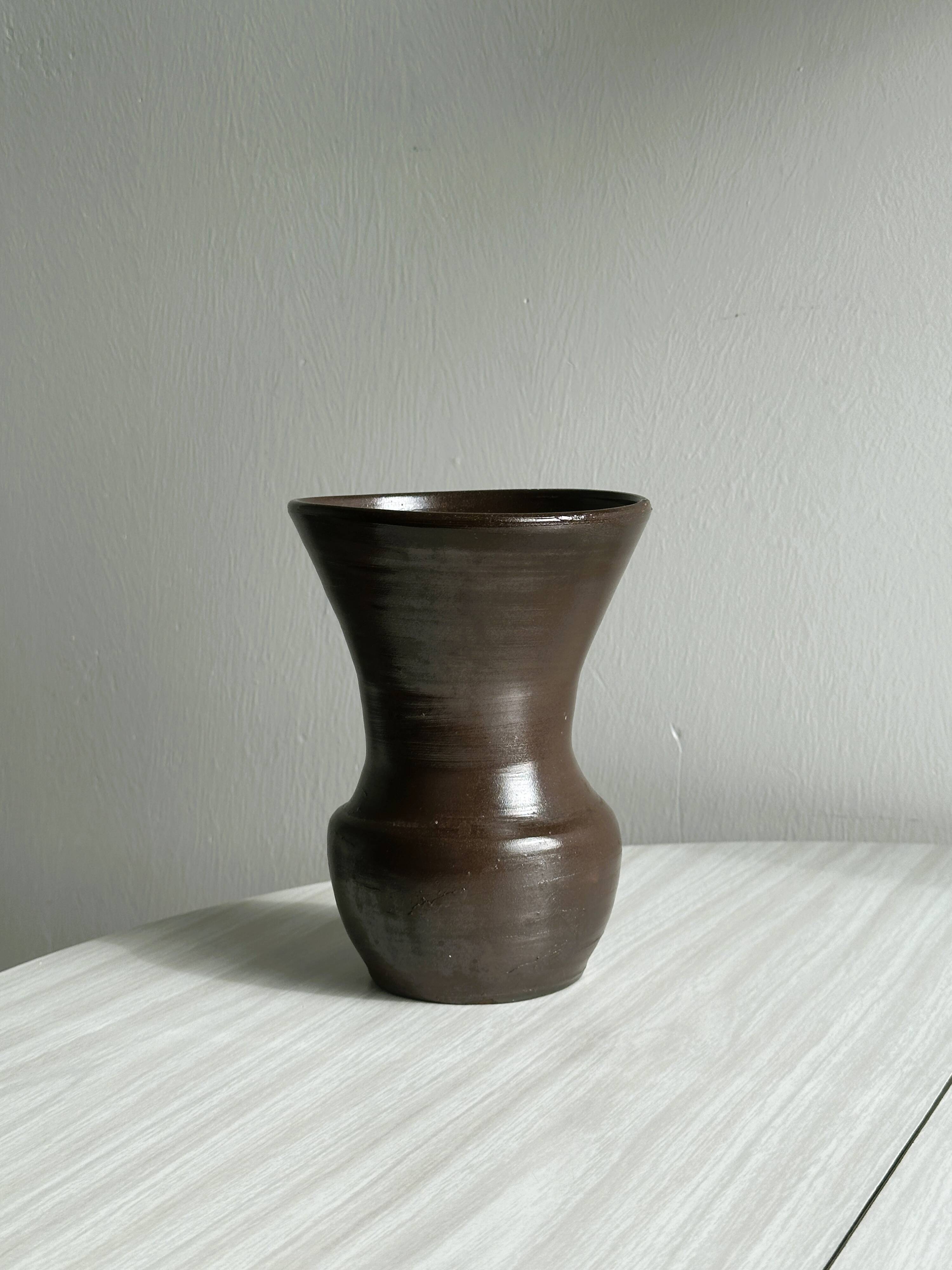 Dark brown ceramic vase, flared shape, smooth finish, classic style