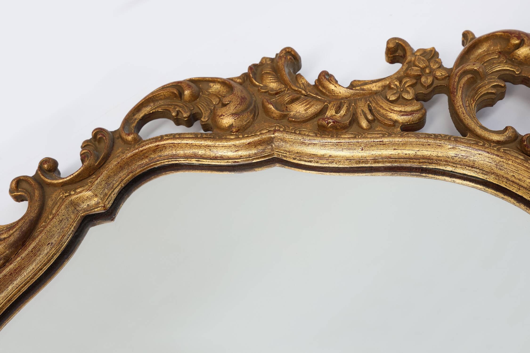 Baroque style oval wall mirror in gilded wood, France