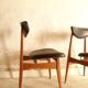 Pair of modernist Scandinavian chairs in teak and black faux leather.