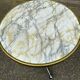 Round bistro table with a central pedestal, gold marble effect and black steel, 60cm.