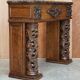 Antique fireplace from around 1880 in solid hand-carved elm with openwork columns.