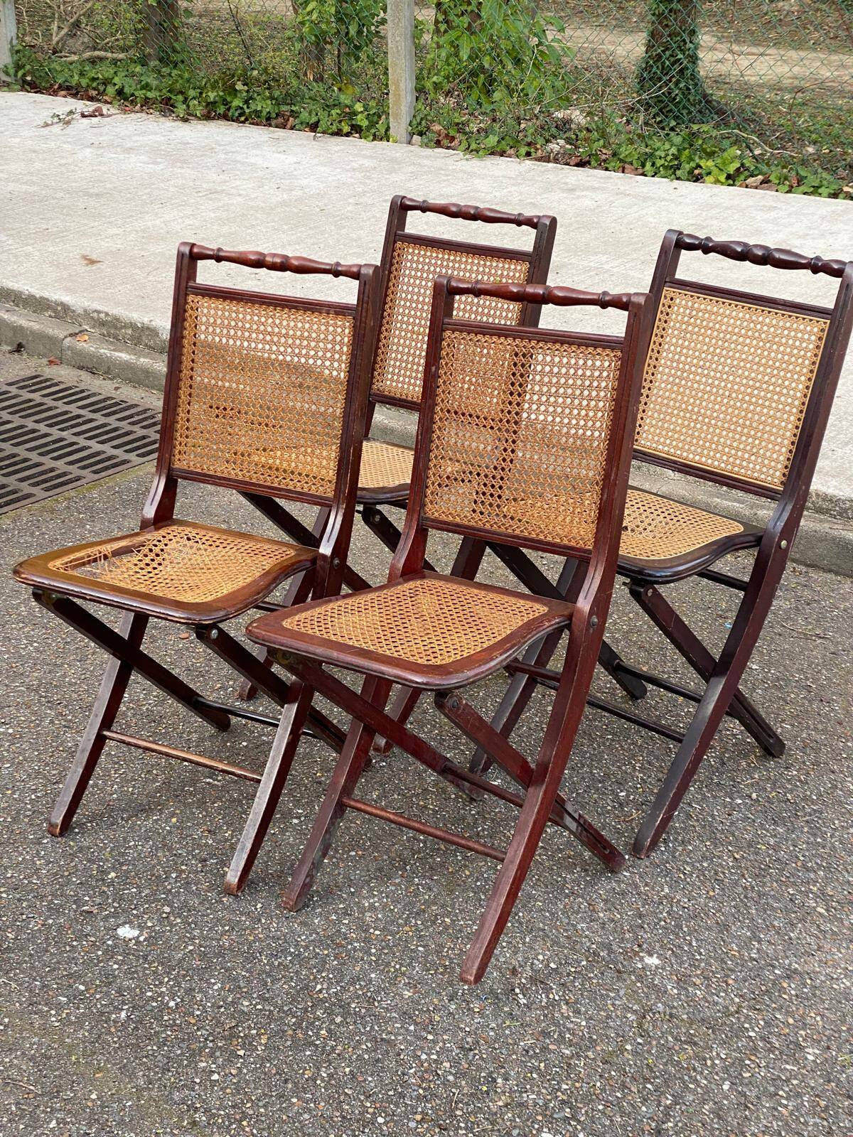 4 cane-seated solid wood folding chairs to be repaired.