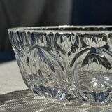 Circular glass ashtray with stylized petal patterns