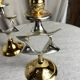 Pair of silver and gold metal candlesticks