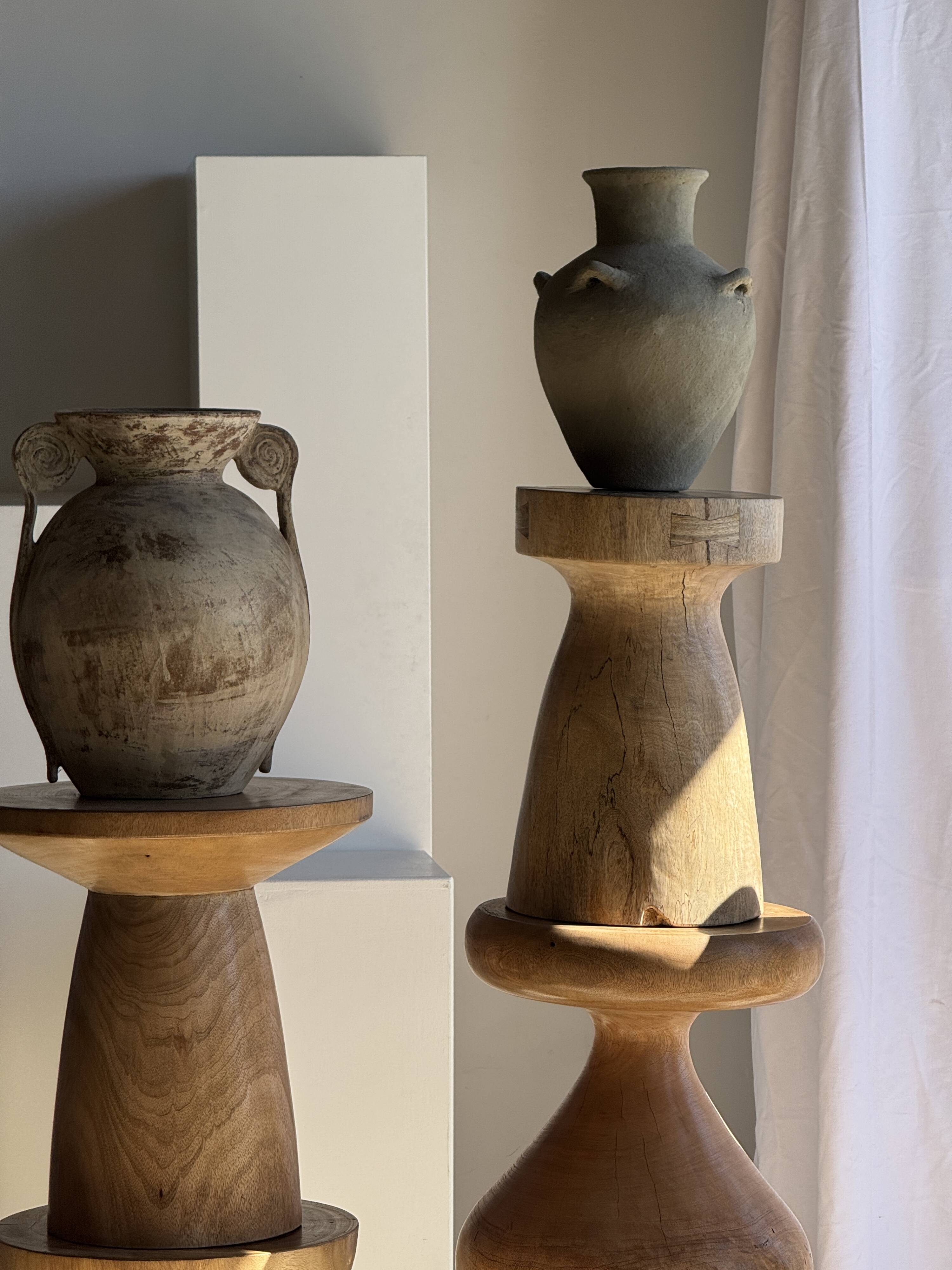 Light beige-grey Indonesian terracotta vase with 4 small handles and a high neck.