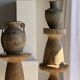 Light beige-grey Indonesian terracotta vase with 4 small handles and a high neck.
