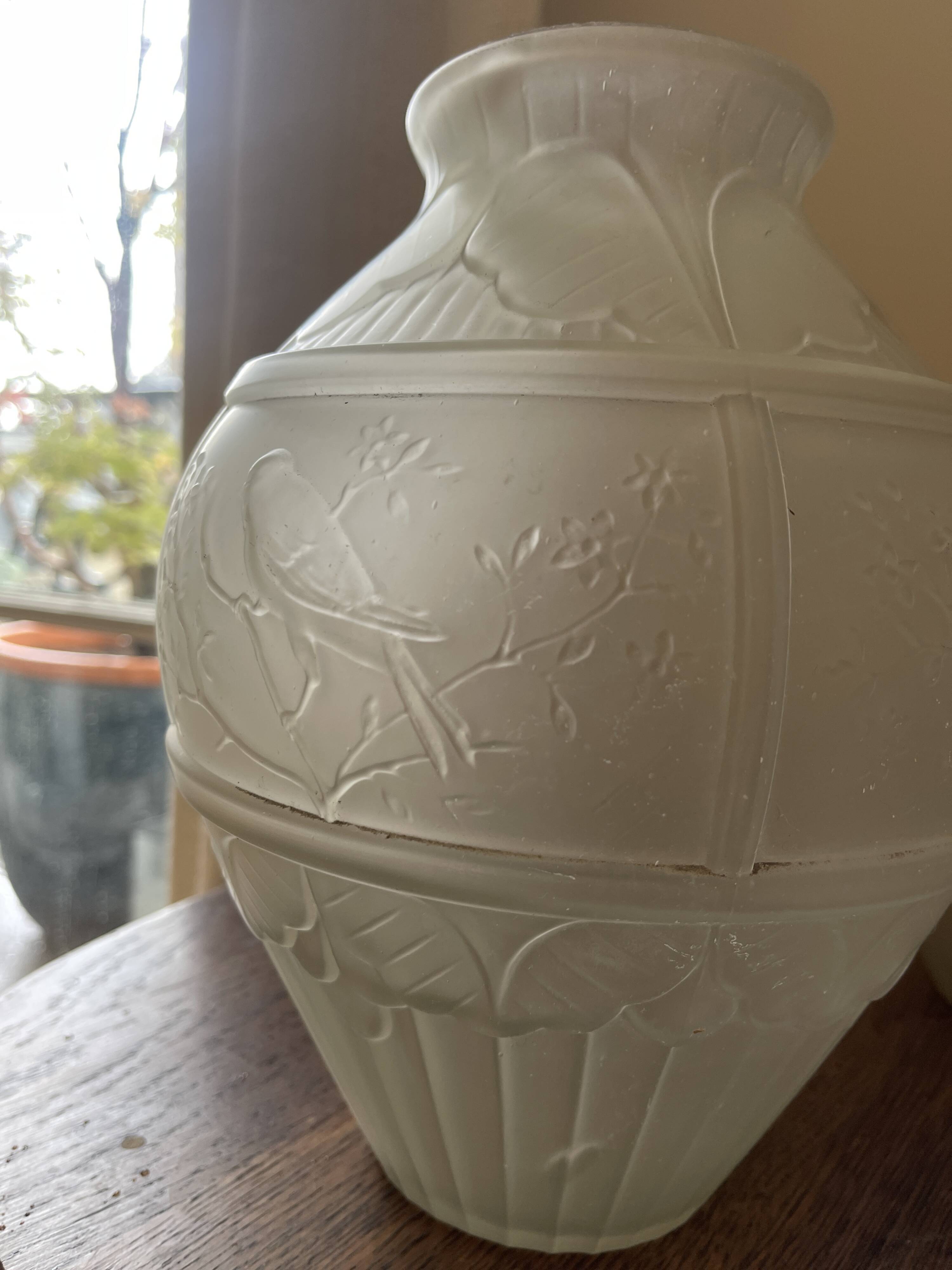 2 semi-opaque glass vases with relief bird designs.