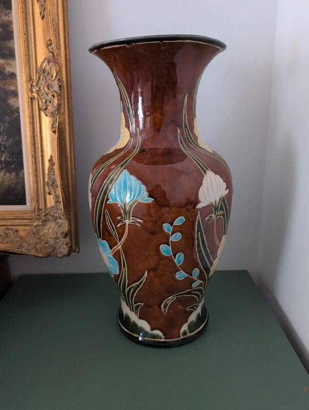Large vintage antique vase with raised floral pattern.