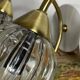 Pair of wall sconces in brass with transparent tulip glass shade.
