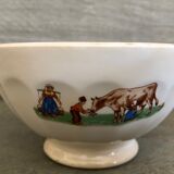 Old bowl decorated with a farmer and her cow