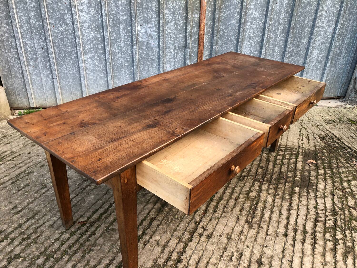 Antique chestnut farmhouse table with 3 drawers on the front.