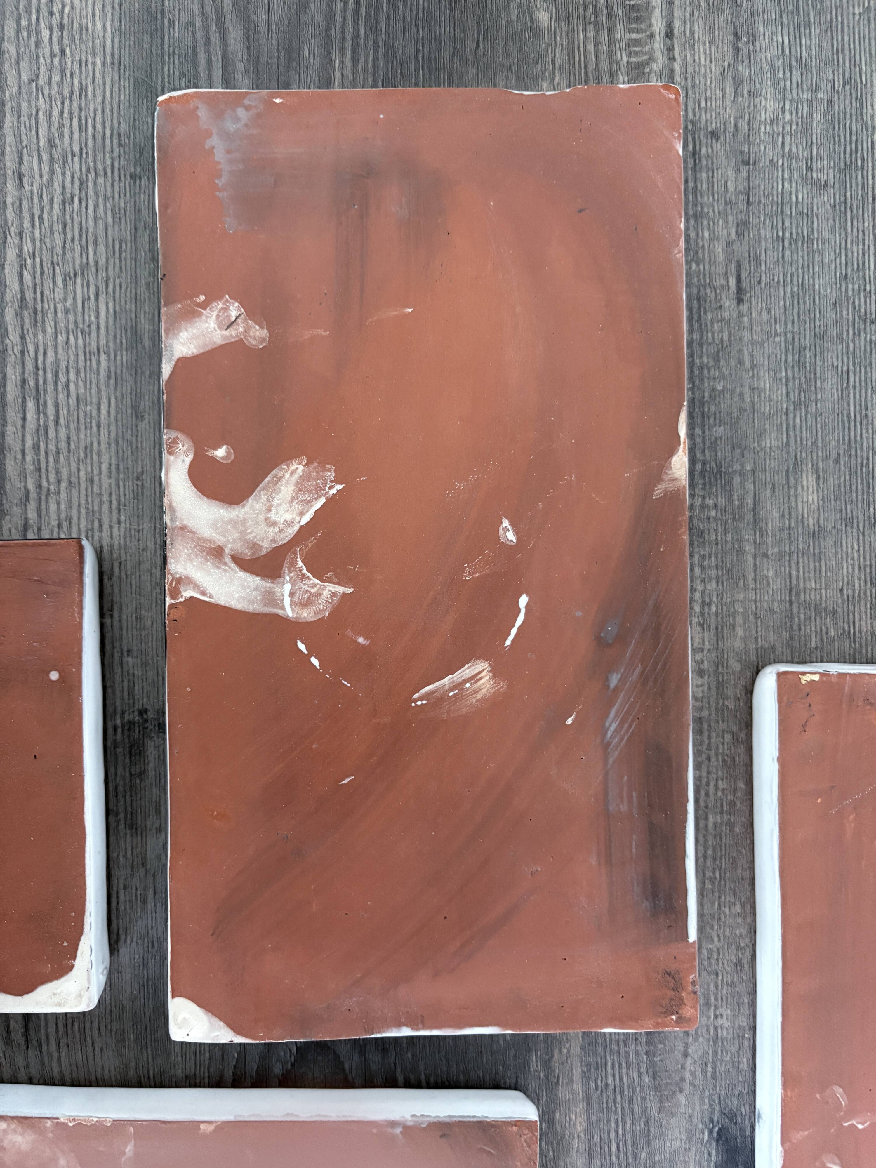 Lot of 4 rectangular glazed terracotta plates.