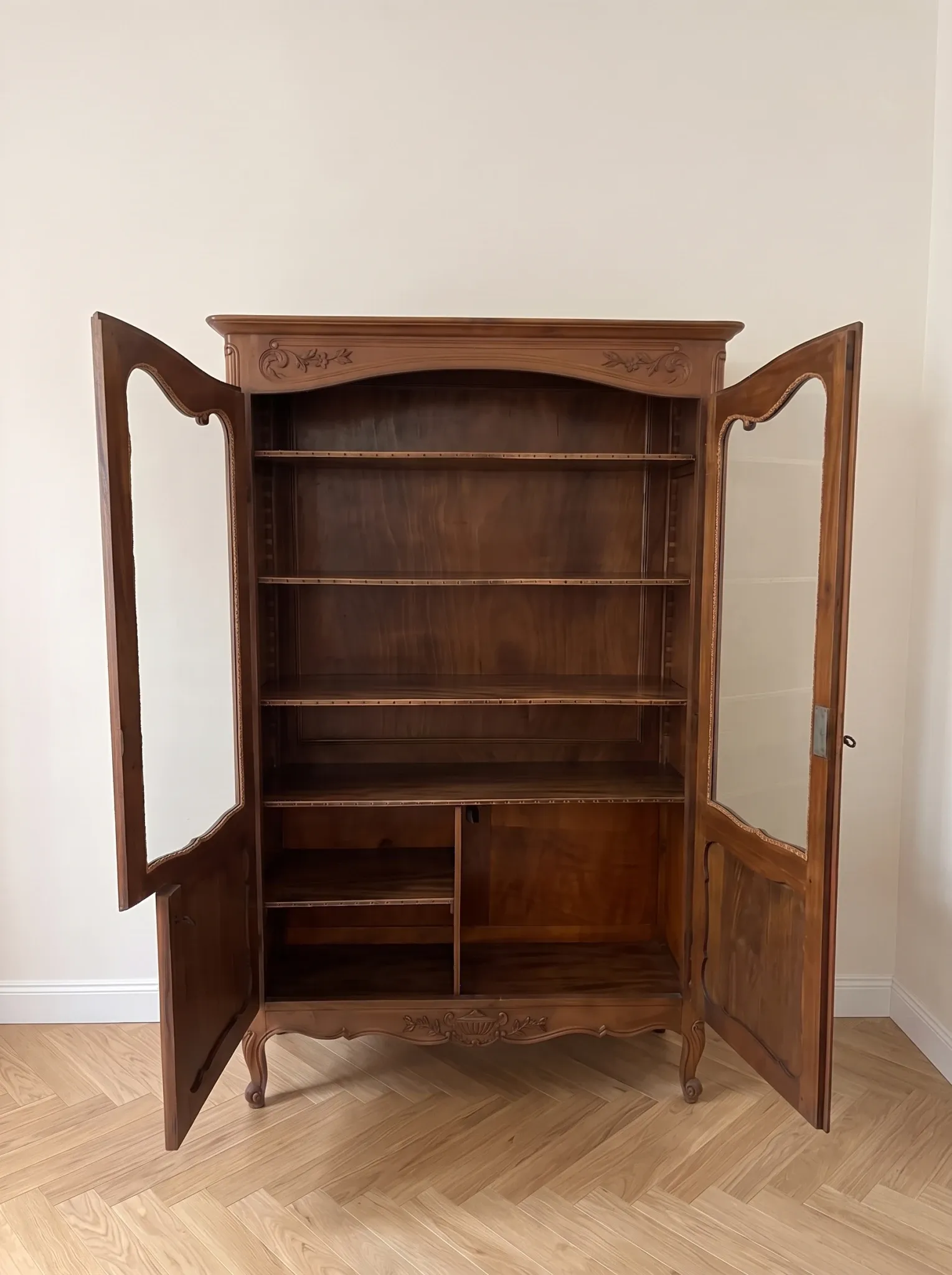 Antique display cabinet in Louis XV style made of wood.