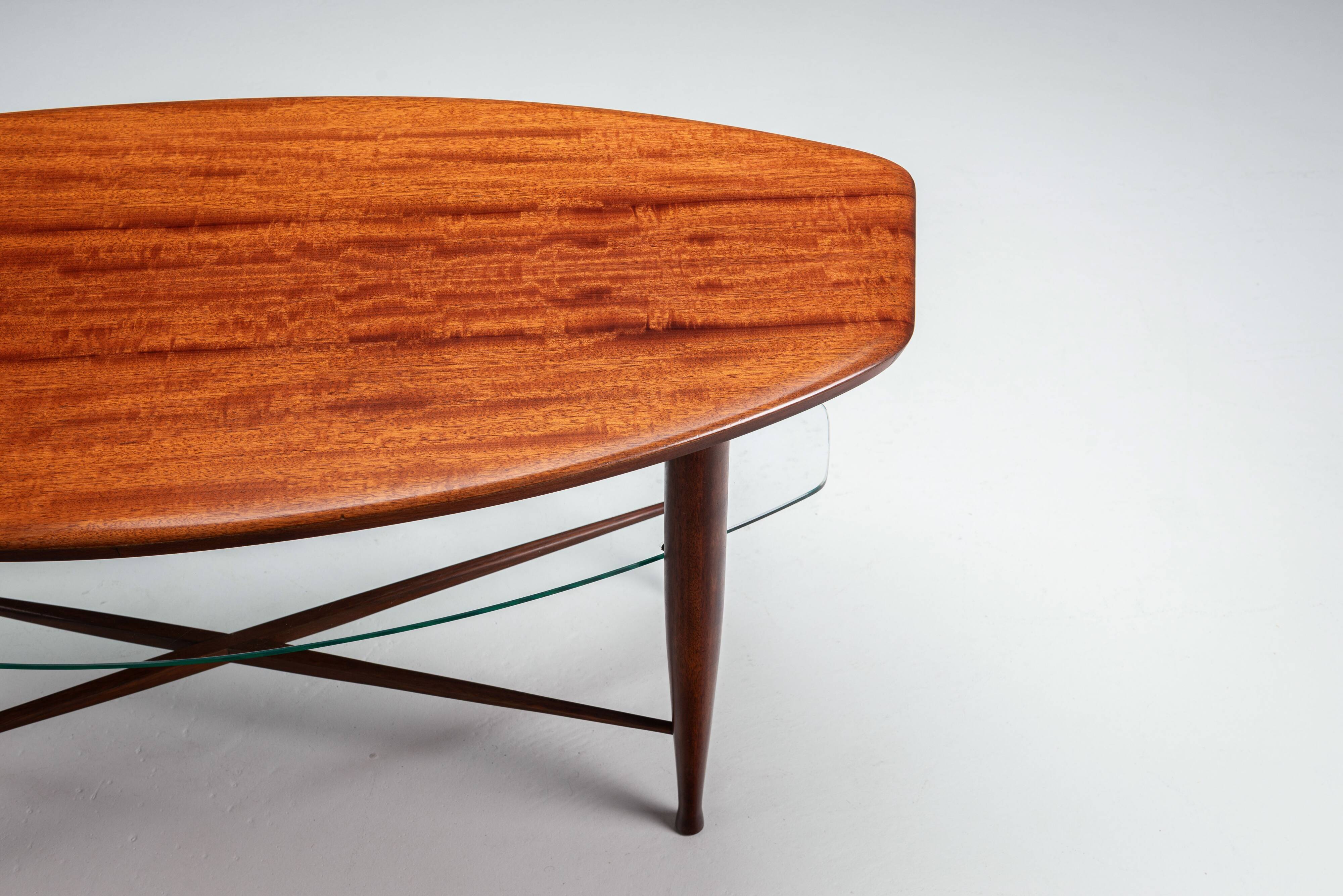 Assymetrical coffeetable with glass storage and cross leg details