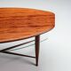 Assymetrical coffeetable with glass storage and cross leg details