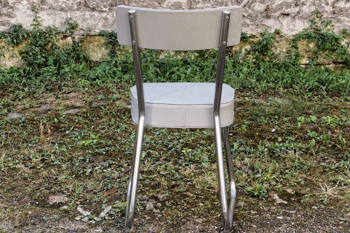 Set of 2 chairs and 1 armchair from the 70s in chrome metal and faux leather.