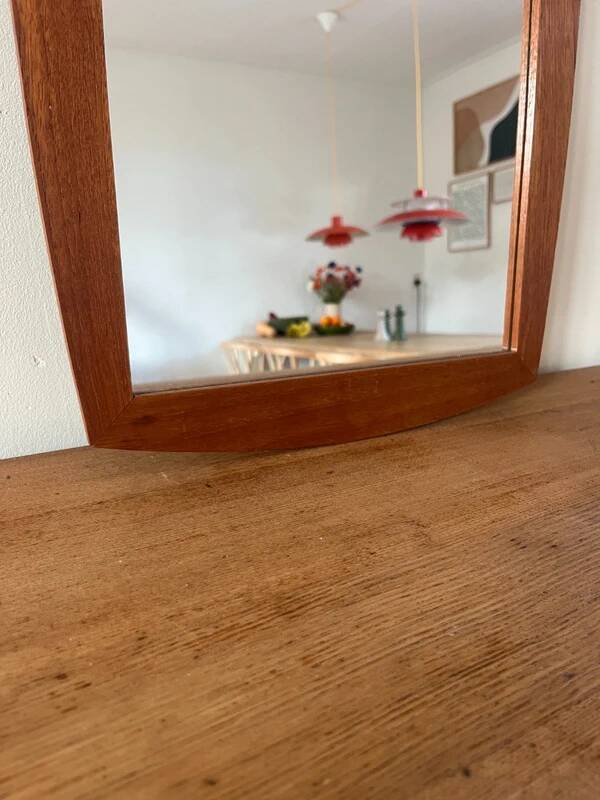 Vintage Danish teak mirror with a rounded back.