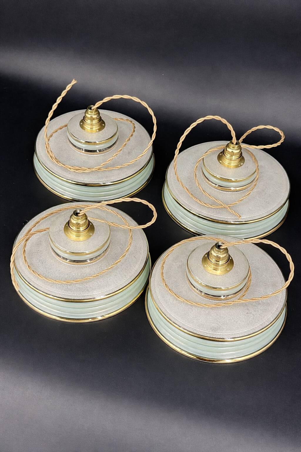 Set of 4 Art Deco pendant lights in frosted water green and gold.