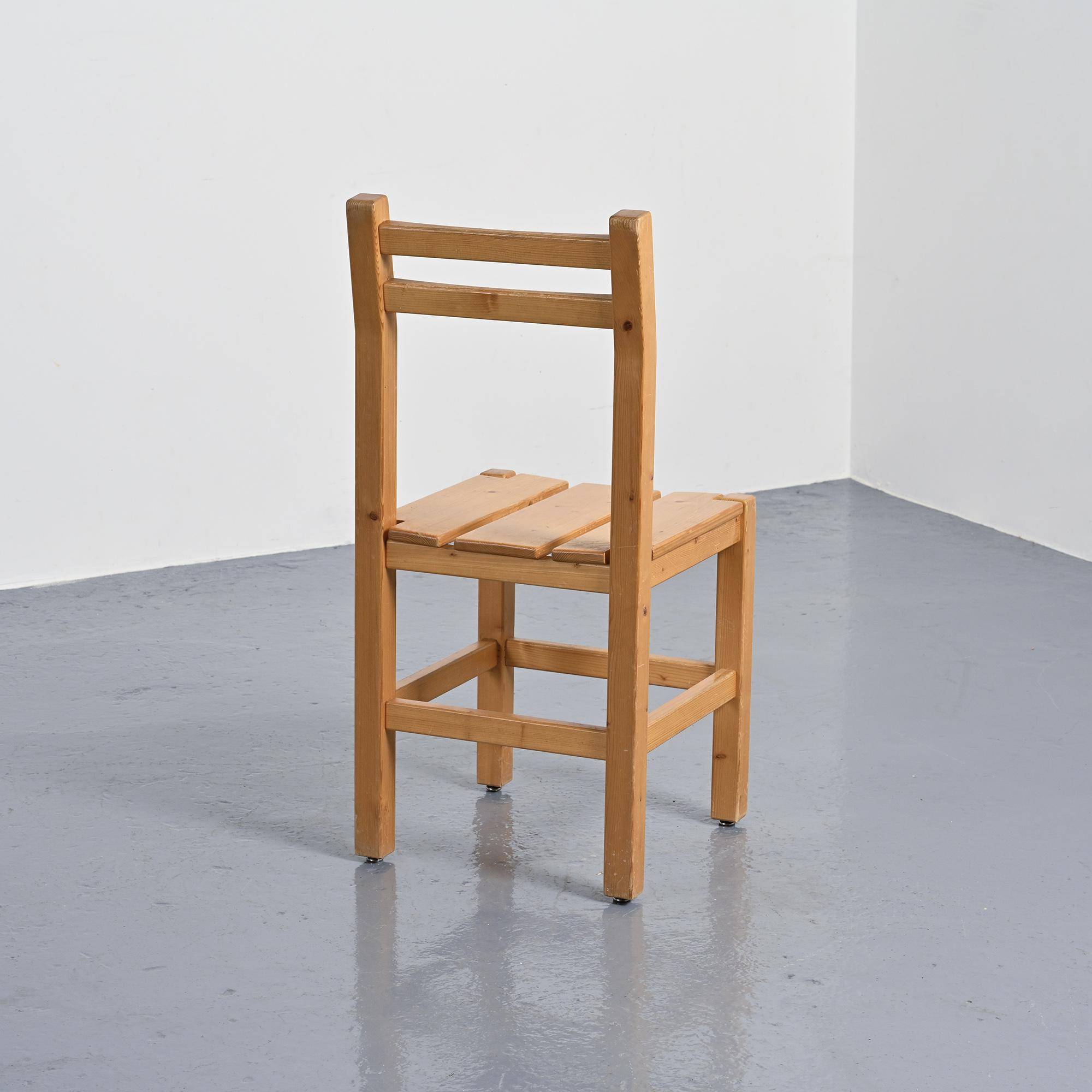 Set of four solid pine chairs by Maison Regain.