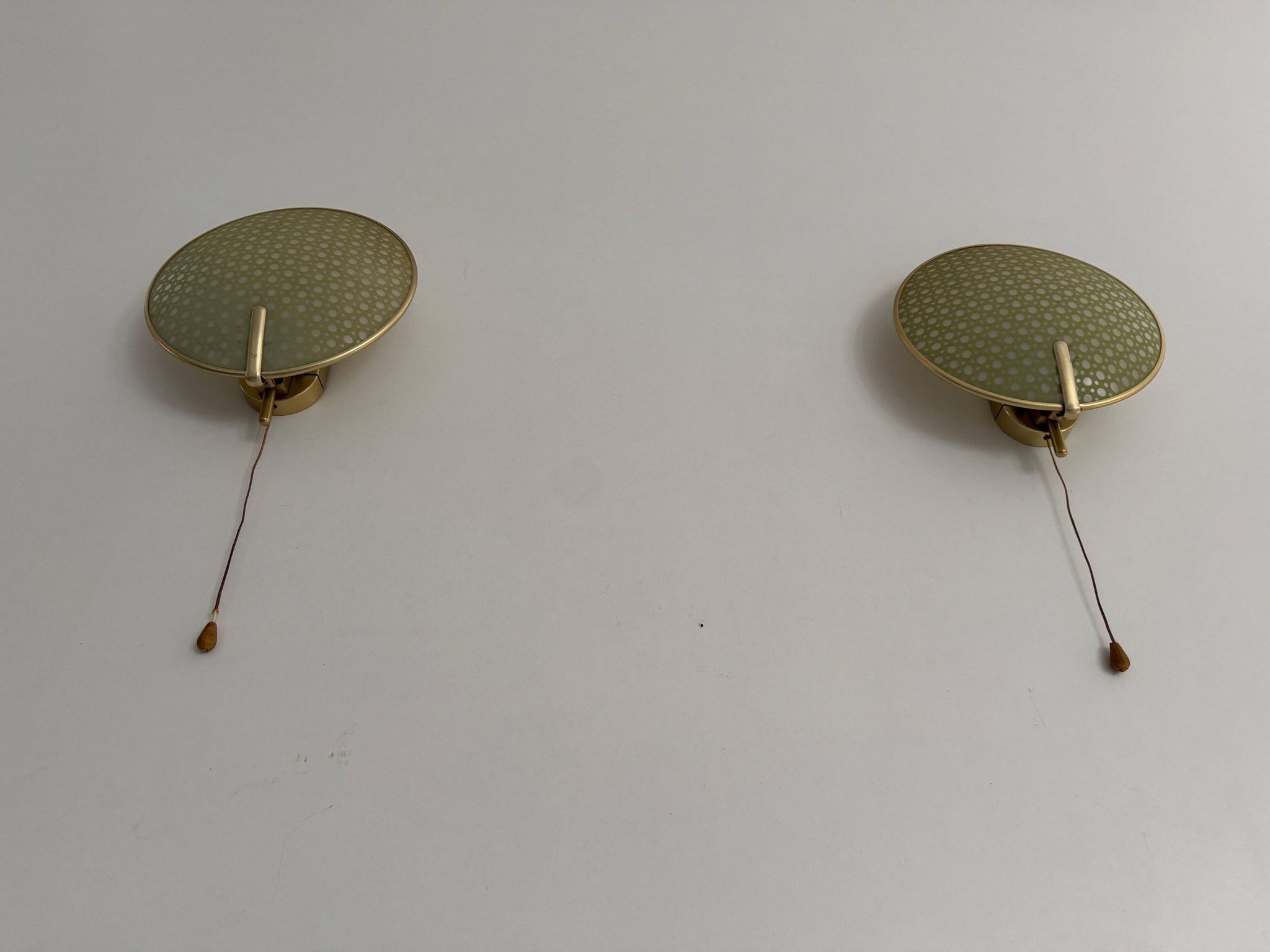 Pair of green plexiglass and gold metal wall lights by Erco, 1950s, Germany.
