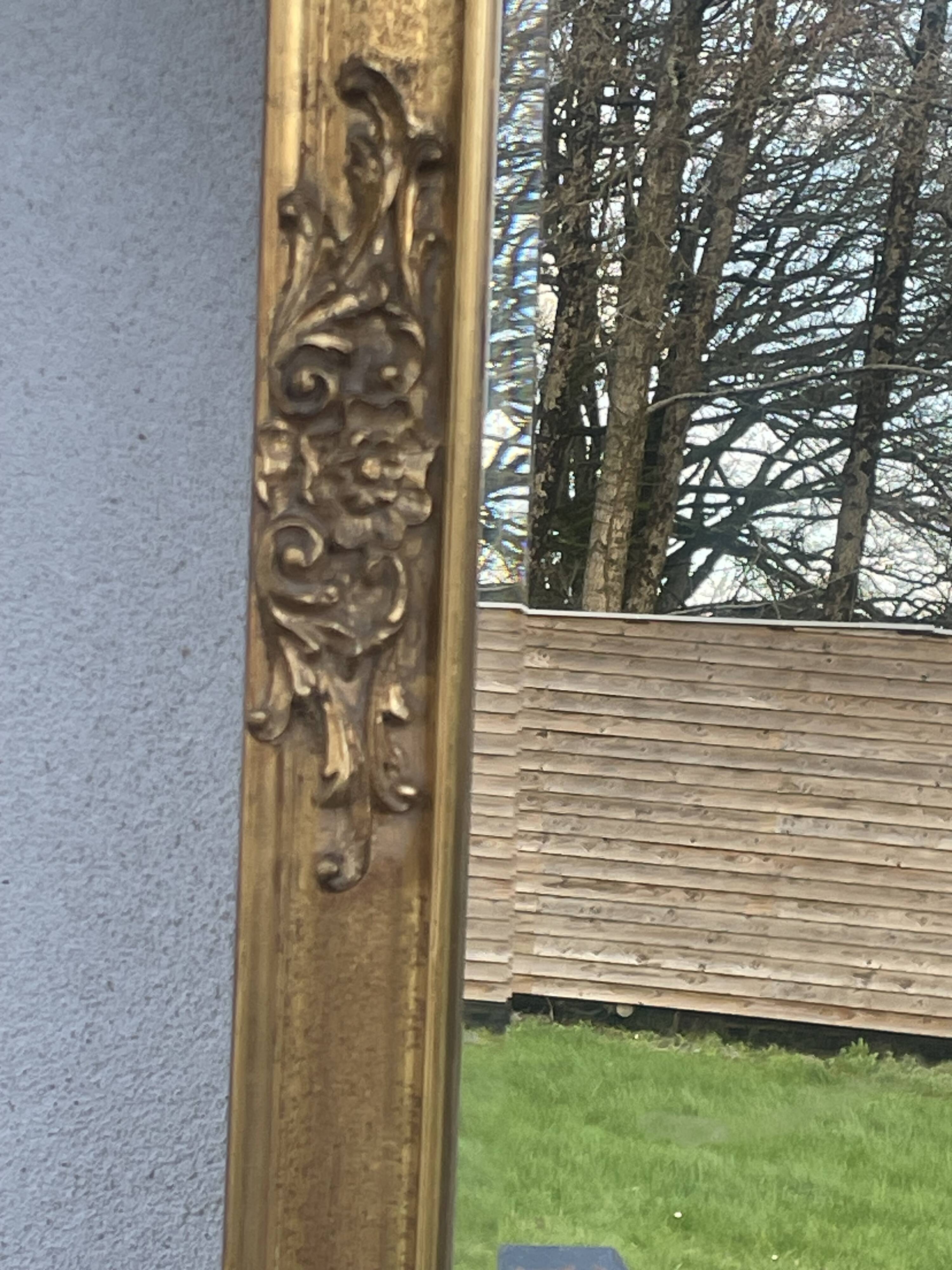 vintage bevelled mirror in rectangular shape, stucco and gilded wood in Louis XV baroque style