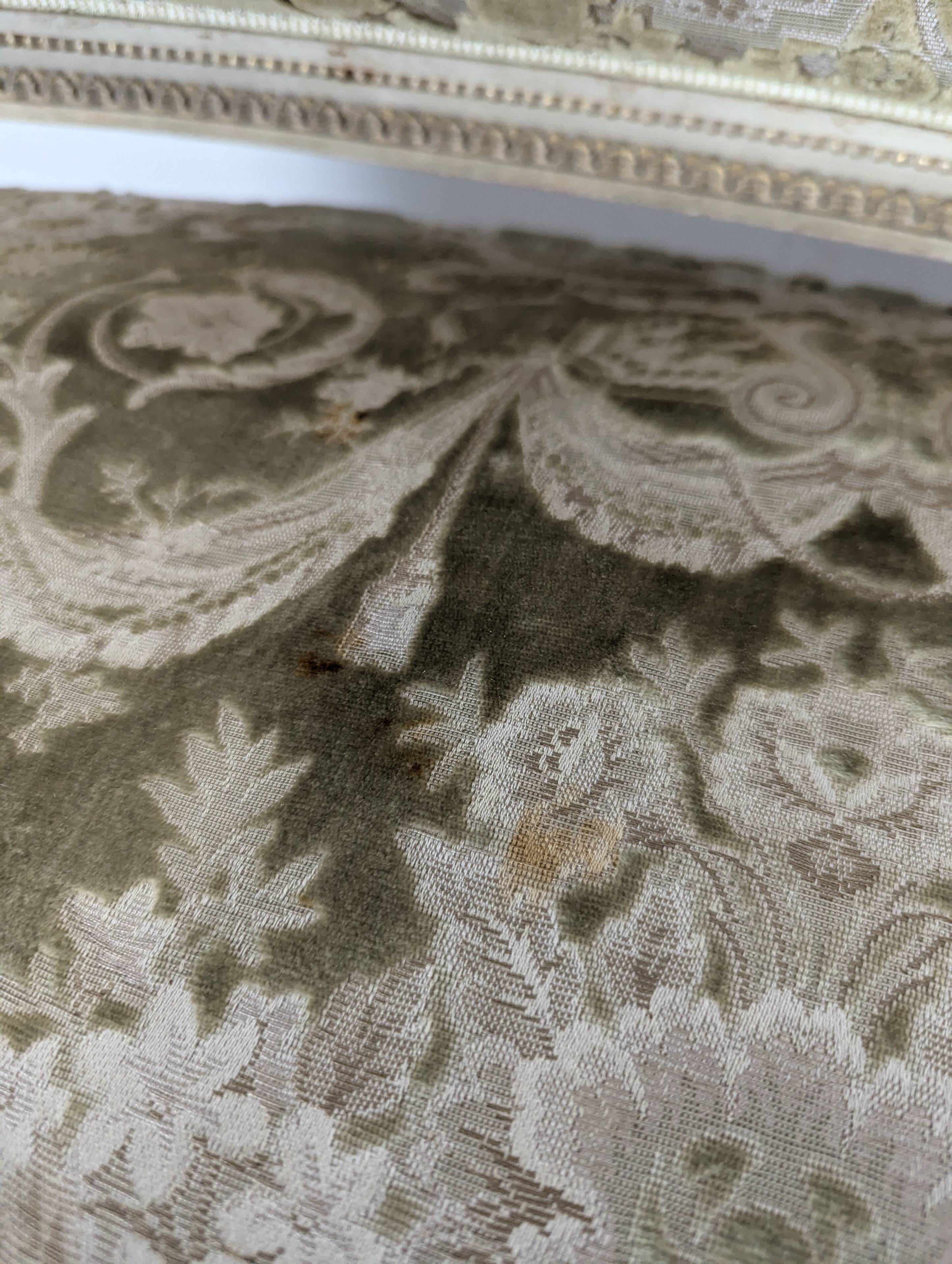 Cream lacquered Louis XVI style cabriolet salon with gold highlights.