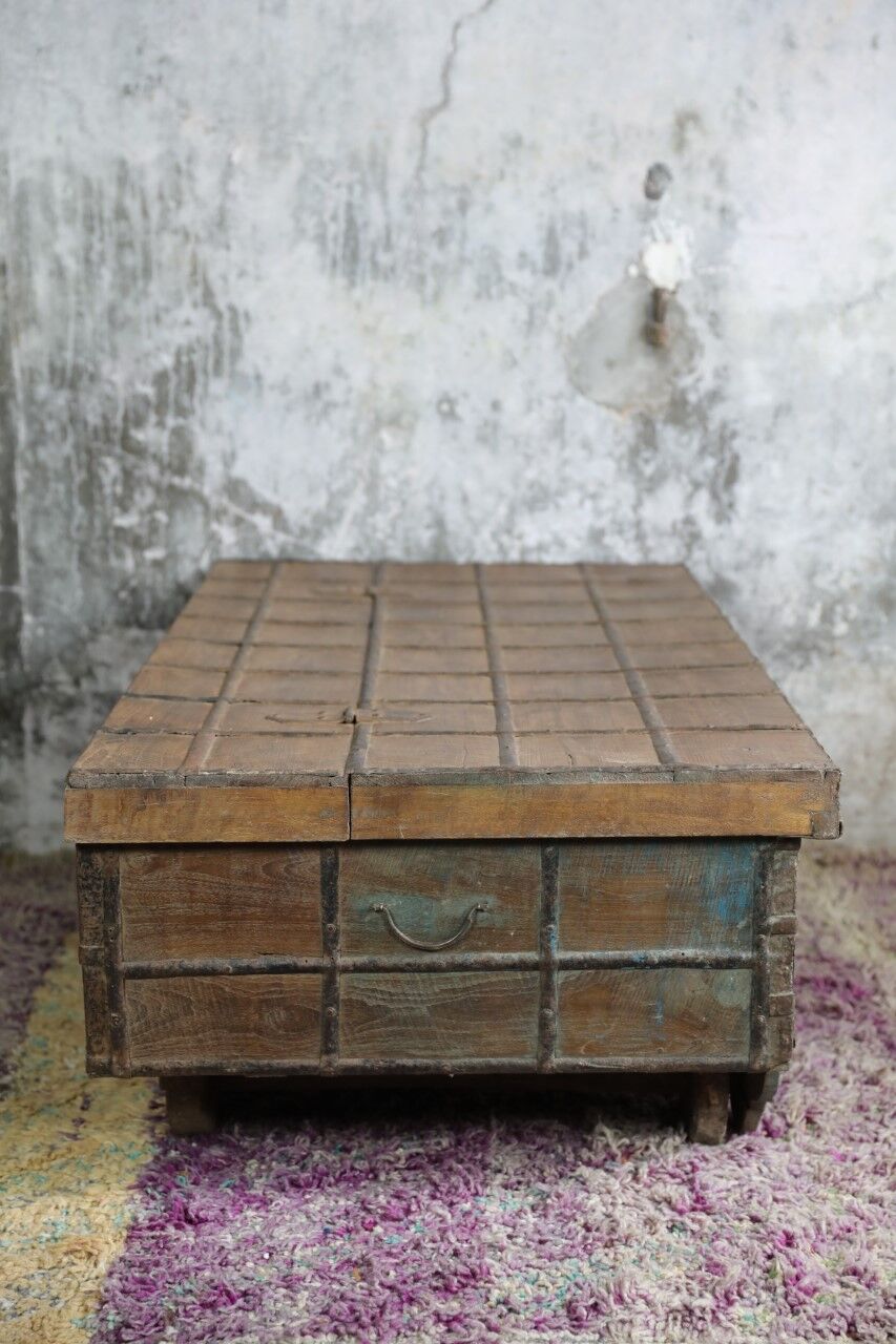 Low chest with metal closure and top opening.