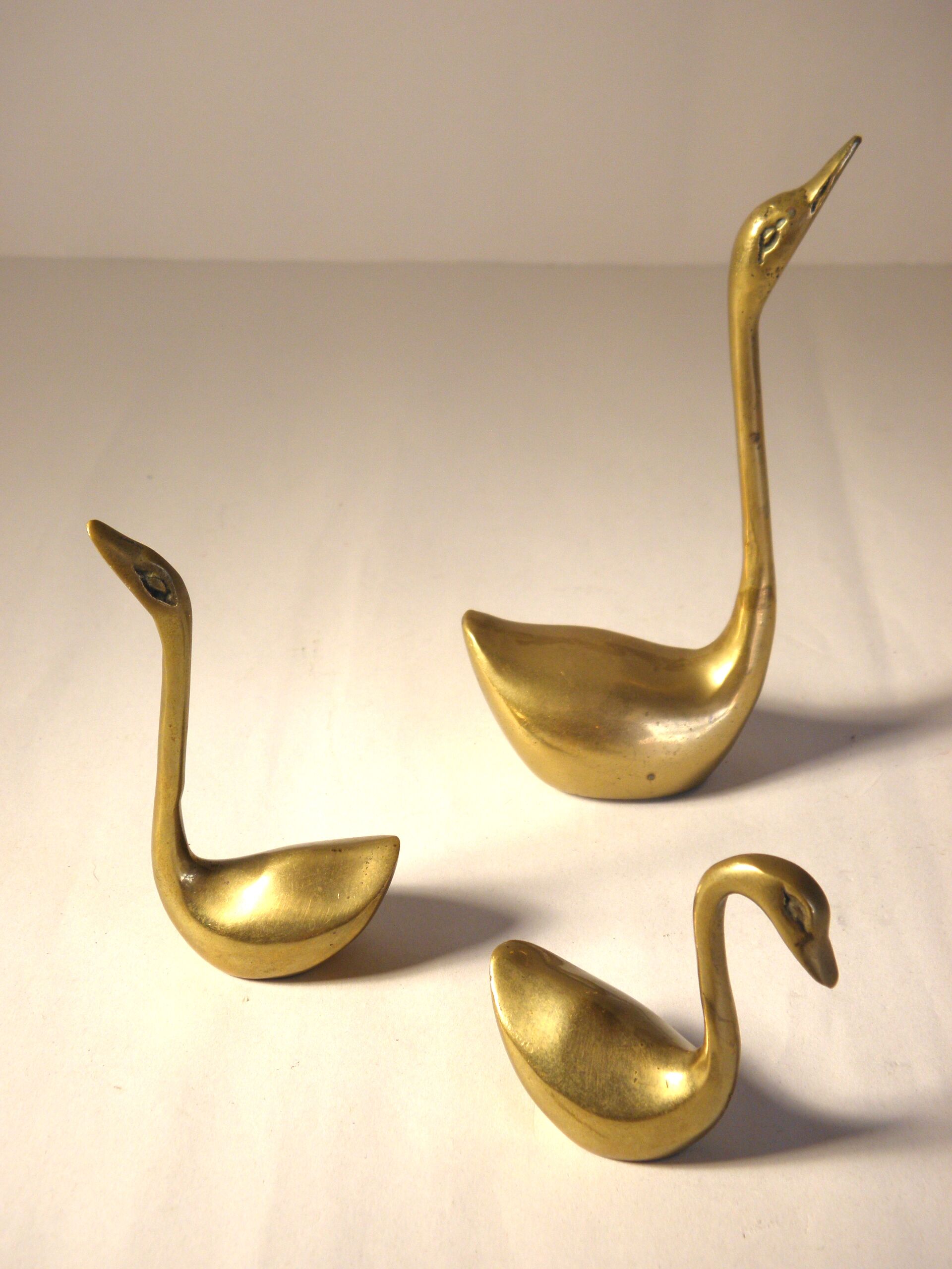 Trio of brass swans
