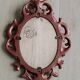 Classic red and gold patinated rocaille mirror, 35 cm x 23 cm