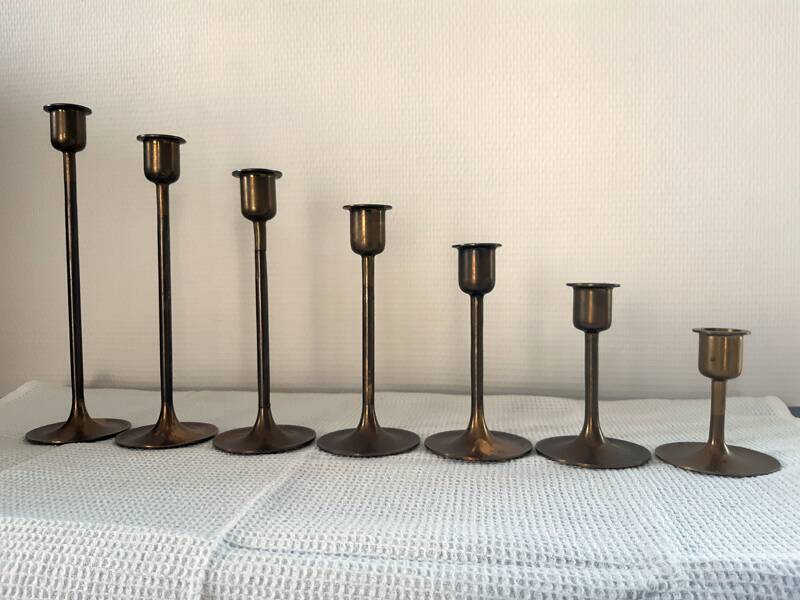 Set of 7 vintage brass candlesticks.