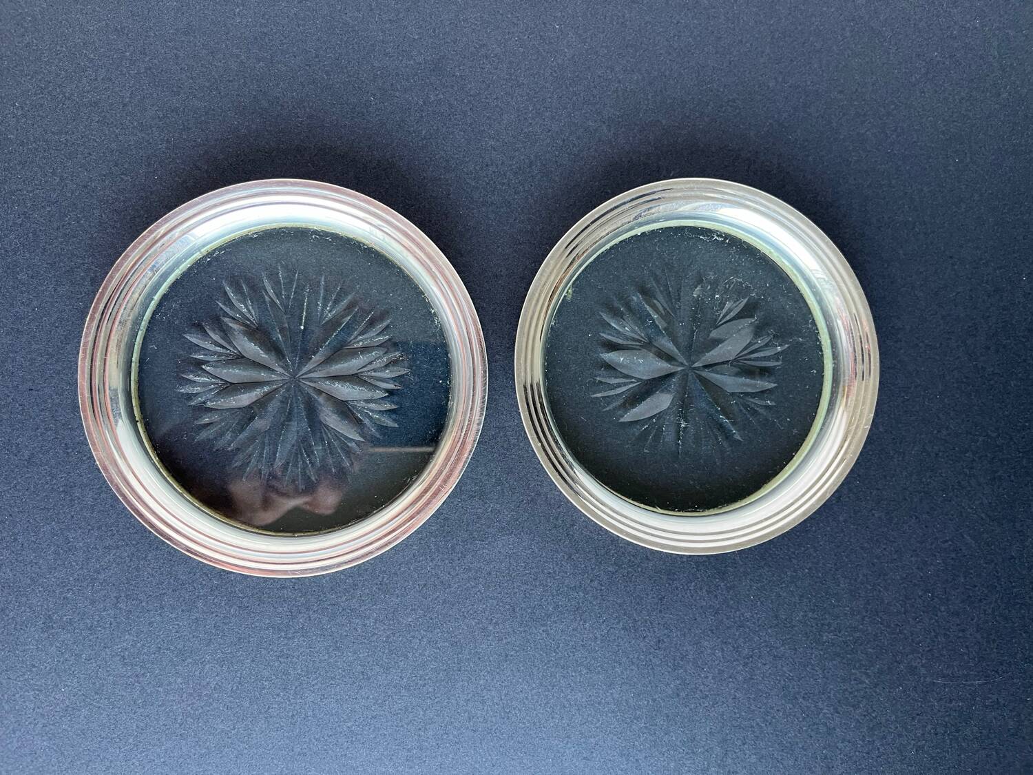 2 Bottle coasters in cut glass and silver metal