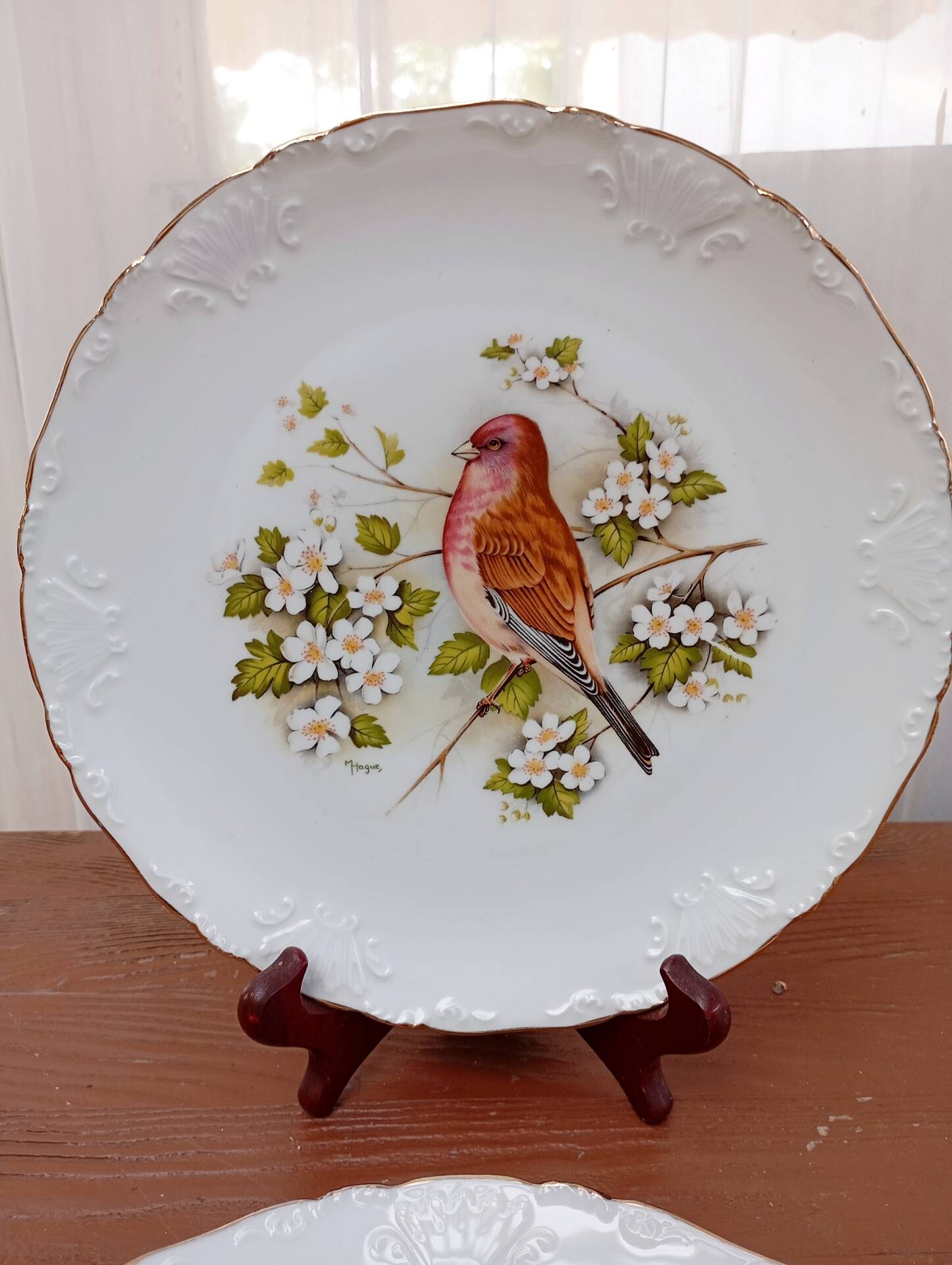 Two Limoges porcelain plates signed M. Hague.