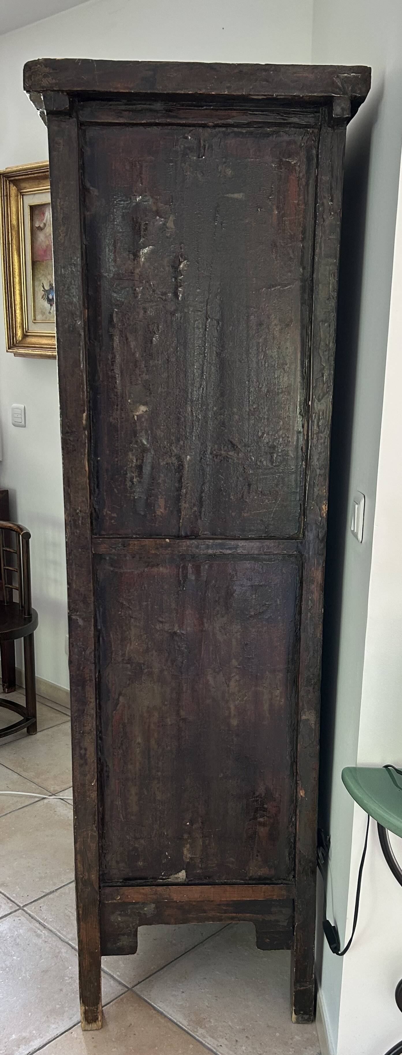 Antique Chinese wardrobe in carved elm.