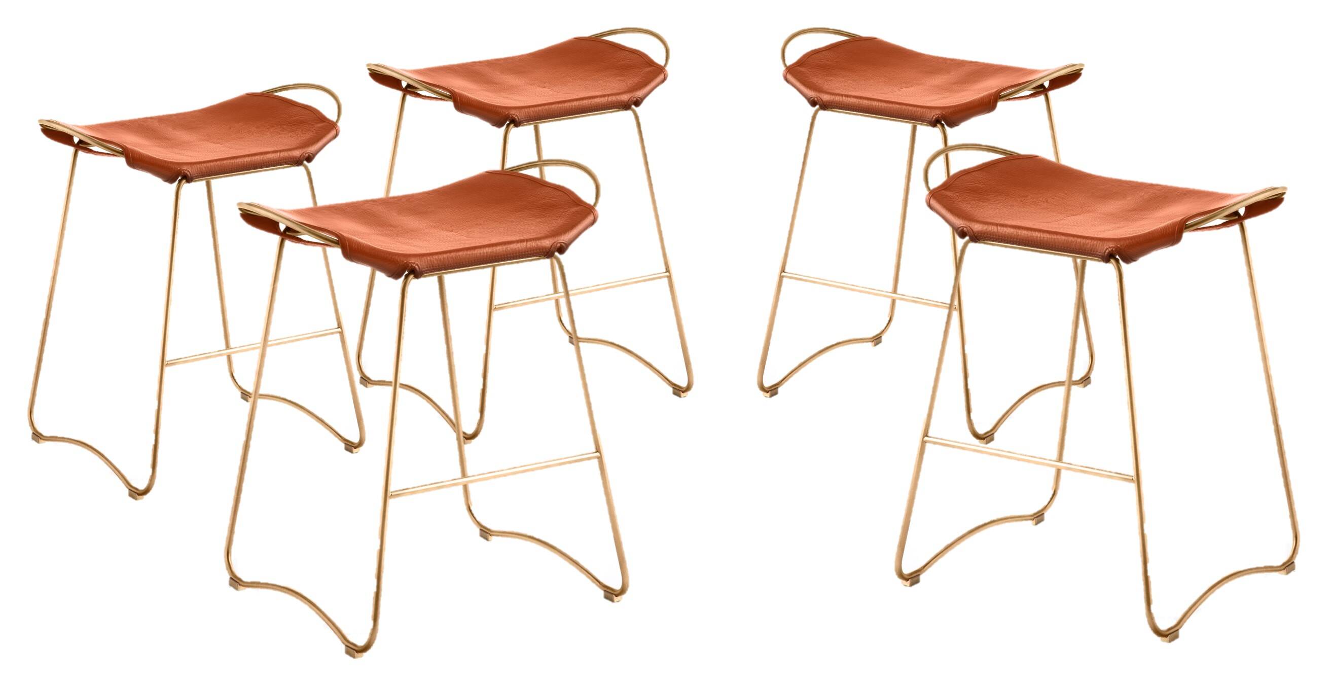 5 contemporary sculptural bar stools in metal, brass, and tobacco leather.