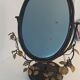 Table mirror, tilting psyche in patinated bronze decorated with leaves and fruits